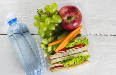 A healthy lunch in a box with a bottle of water